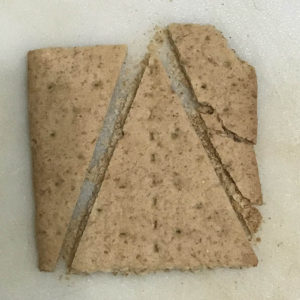 Cutting graham cracker triangle to close up house