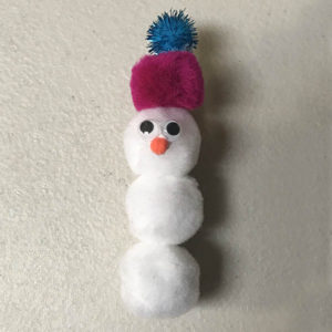 Googly eyes and pom pom nose added to snowman