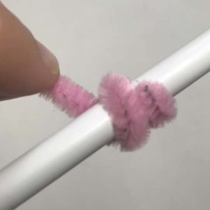 Wrapping pipe cleaner around pencil