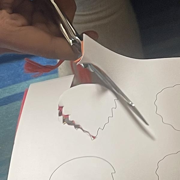 Cutting out gratitude leaves using a leaf outline